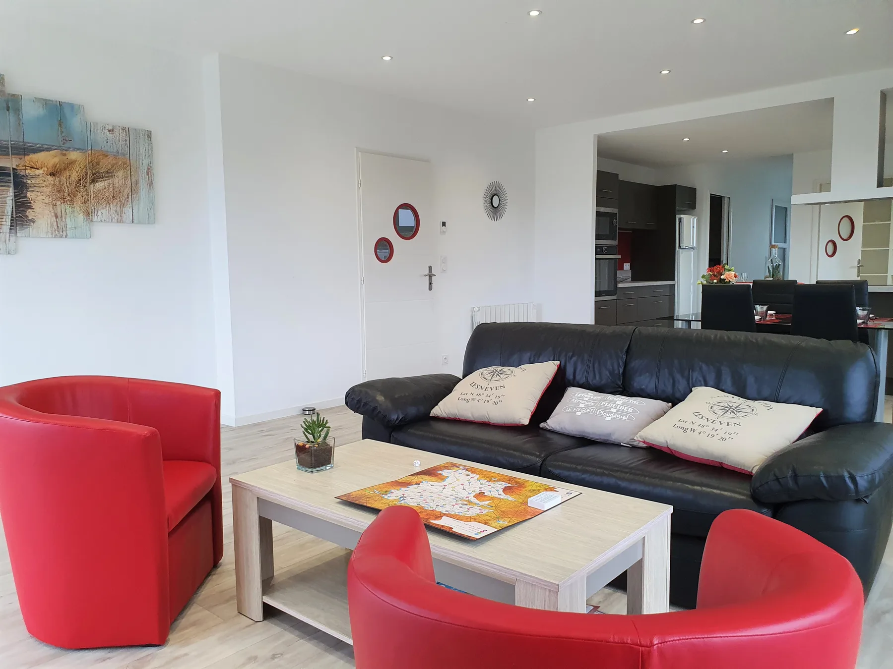 A bright living room with seating arranged around a coffee table.