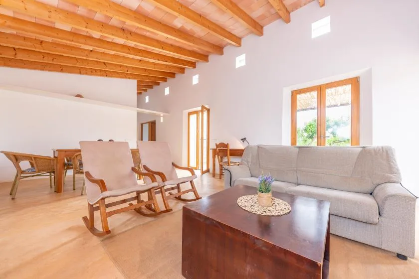 A bright living room with seating around a low coffee table.