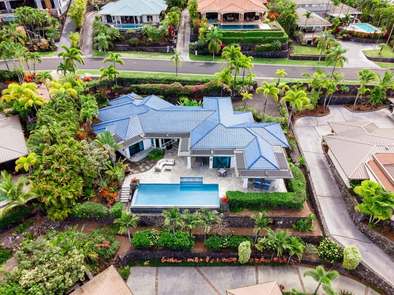 Aerial view of a house with a swimming pool and landscaped garden.
