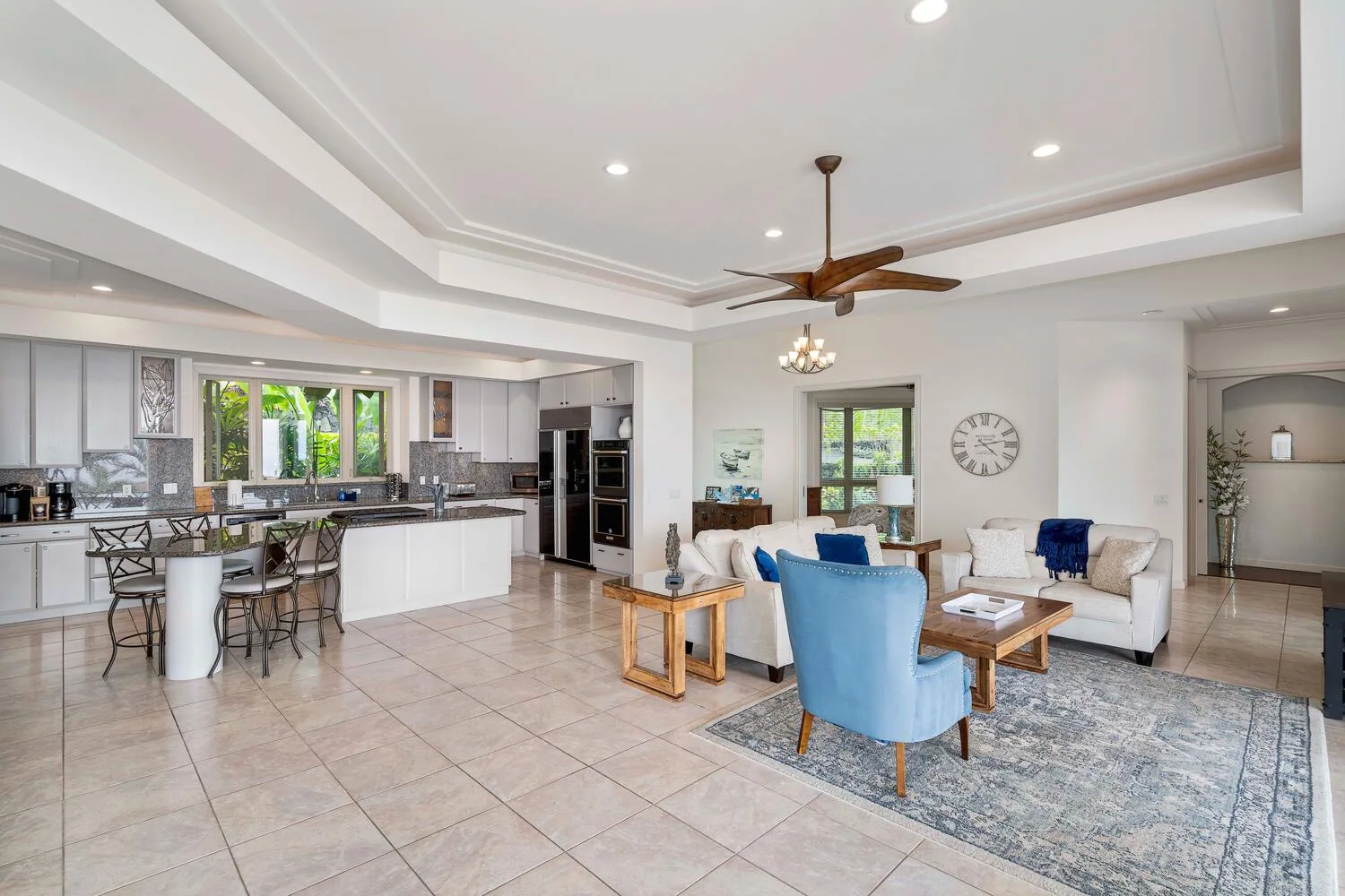 An open-plan living room and kitchen with seating around a coffee table.