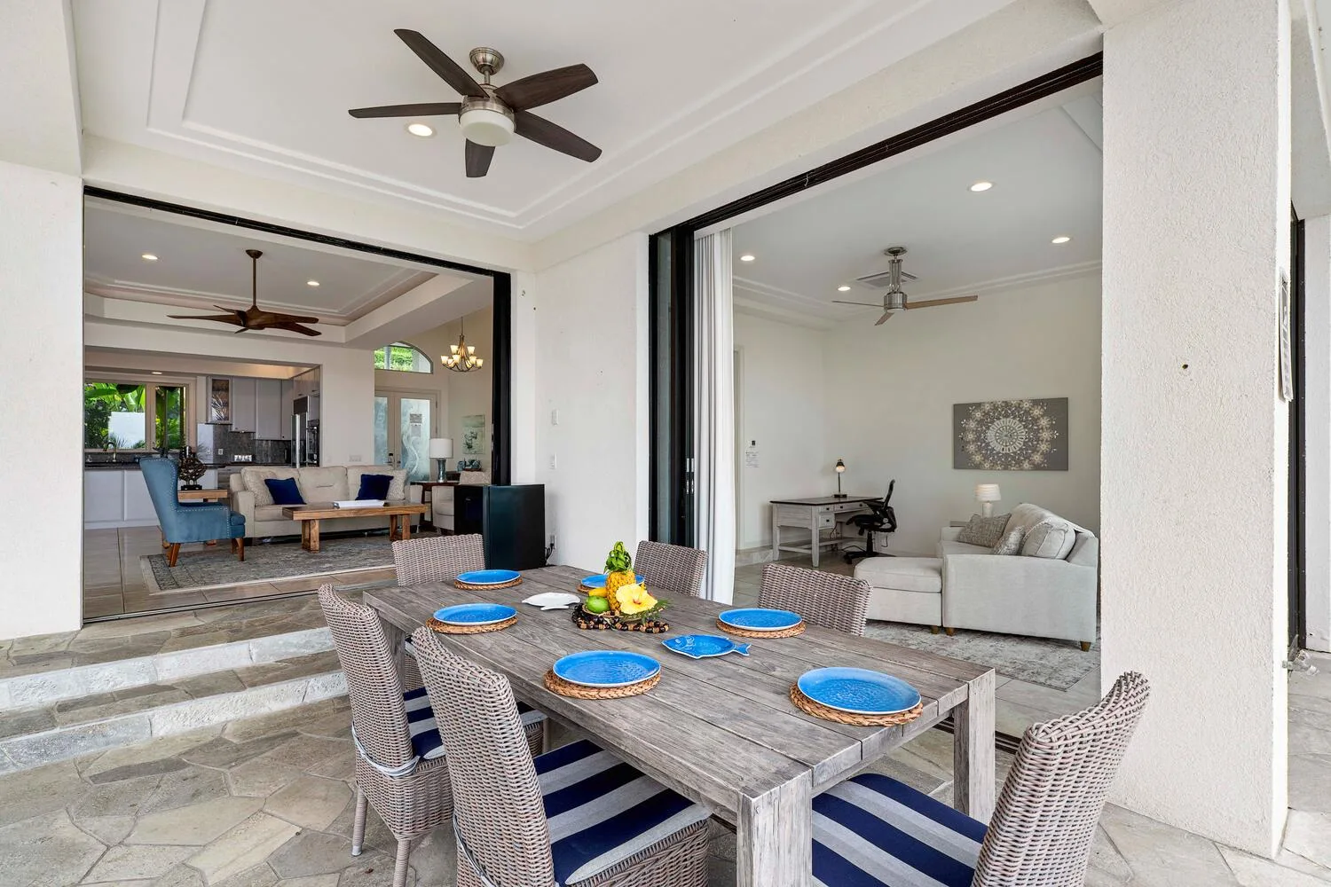 An open-plan dining and living area has a set table and seating.