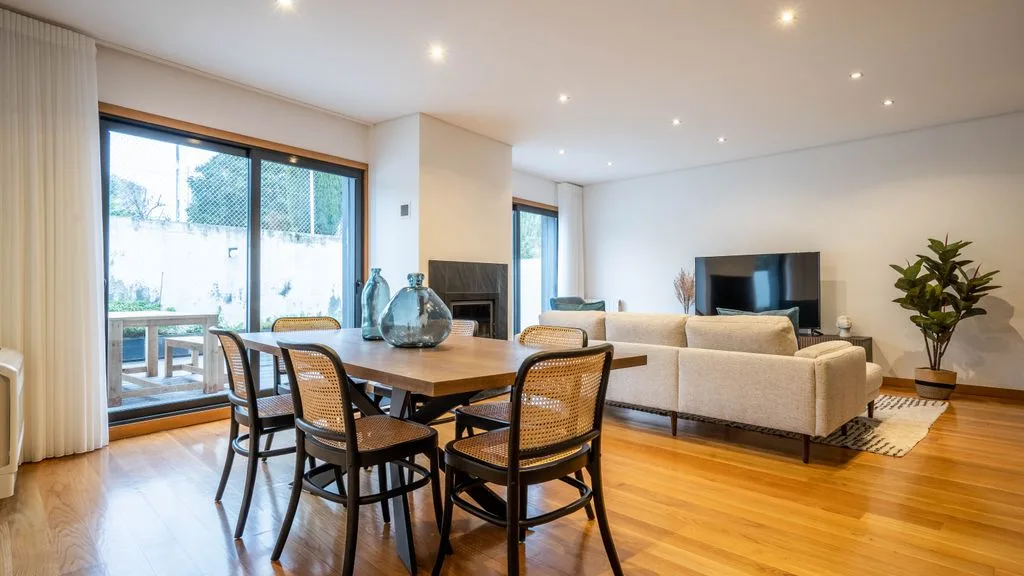 An open-plan living and dining room with a wooden table and seating.