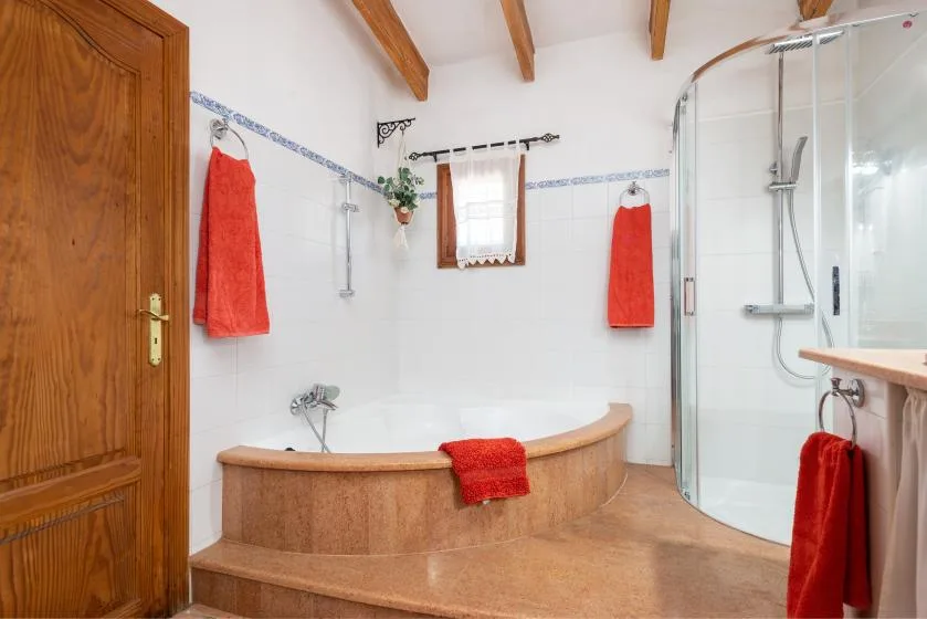 A bathroom with a built-in bathtub and a glass shower.