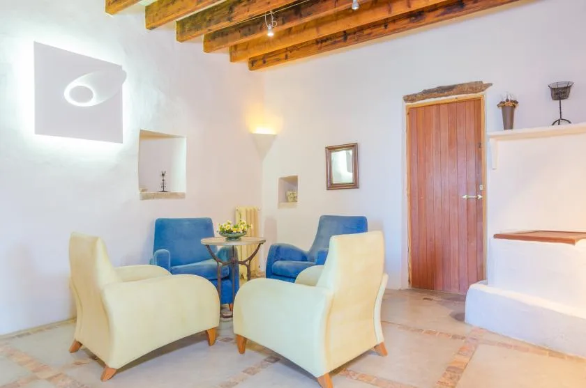 A bright sitting room with armchairs and a small table.