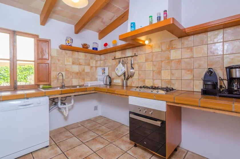 A tiled kitchen with wooden countertops and a built-in oven.