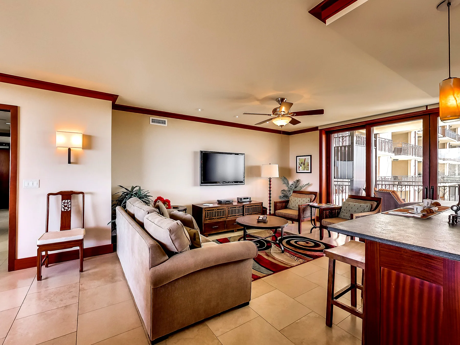 A living room with seating arranged around a television and coffee table.