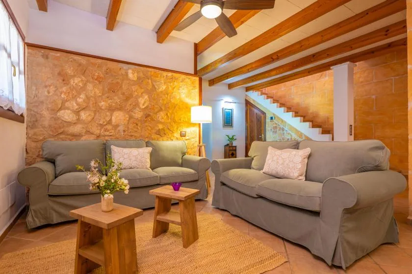 A living room with seating around a low wooden coffee table.