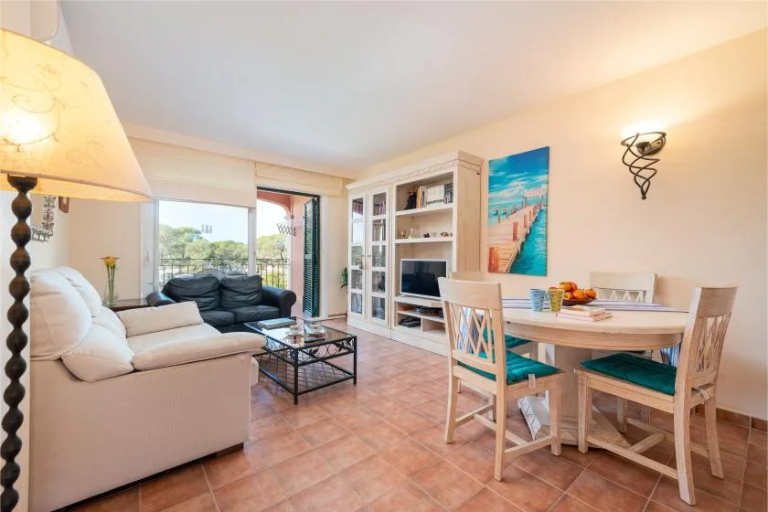 A living and dining area with seating, a coffee table, and a dining table.