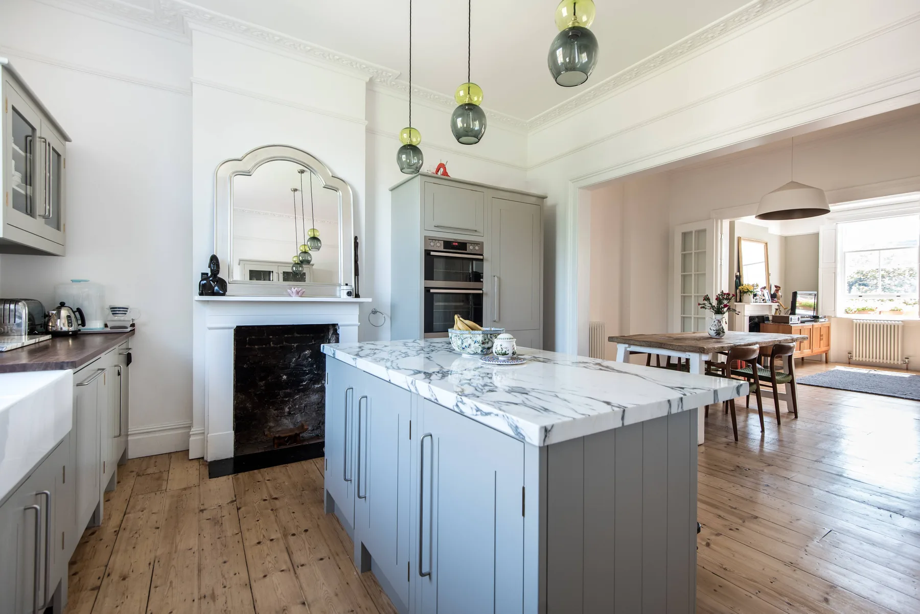 A bright kitchen features a large island and an adjoining dining area.