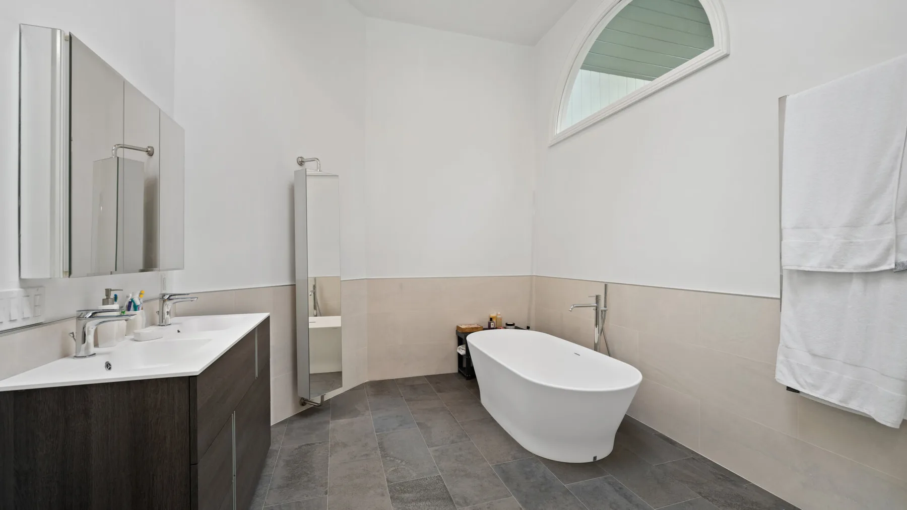 A bathroom with a freestanding bathtub and a vanity.