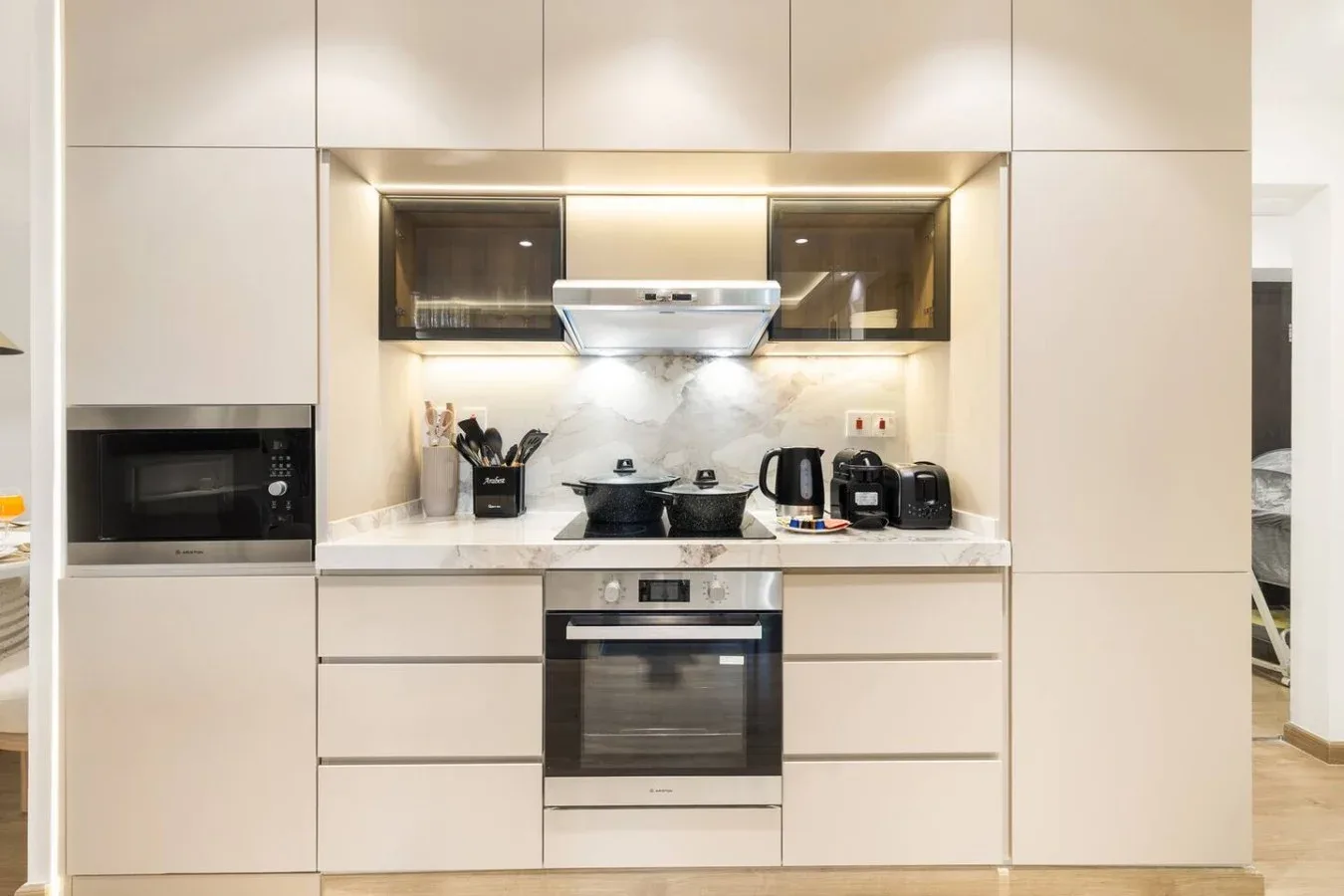 A modern kitchen with built-in appliances and countertop cooking equipment.