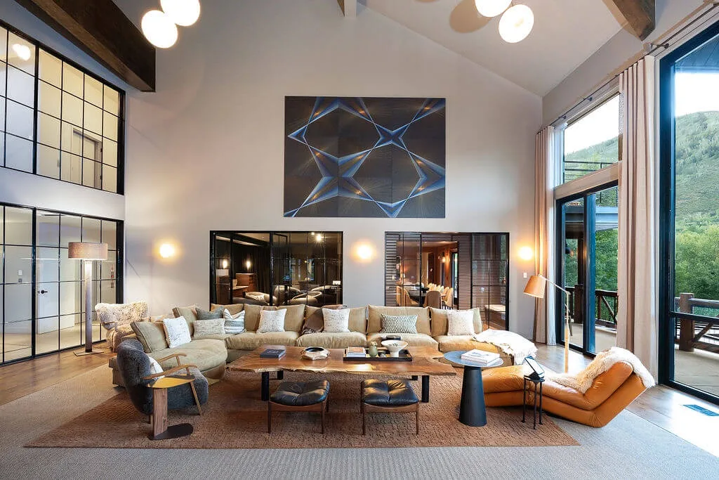 A spacious living room with seating arranged around a low coffee table.