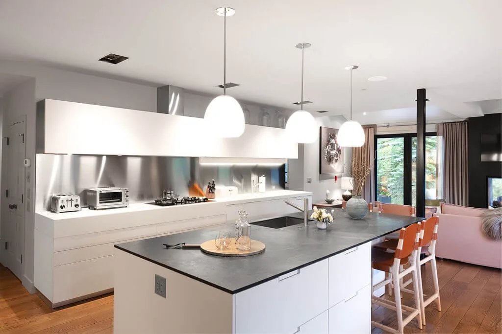 A bright open-plan kitchen with a large island and dining seating.