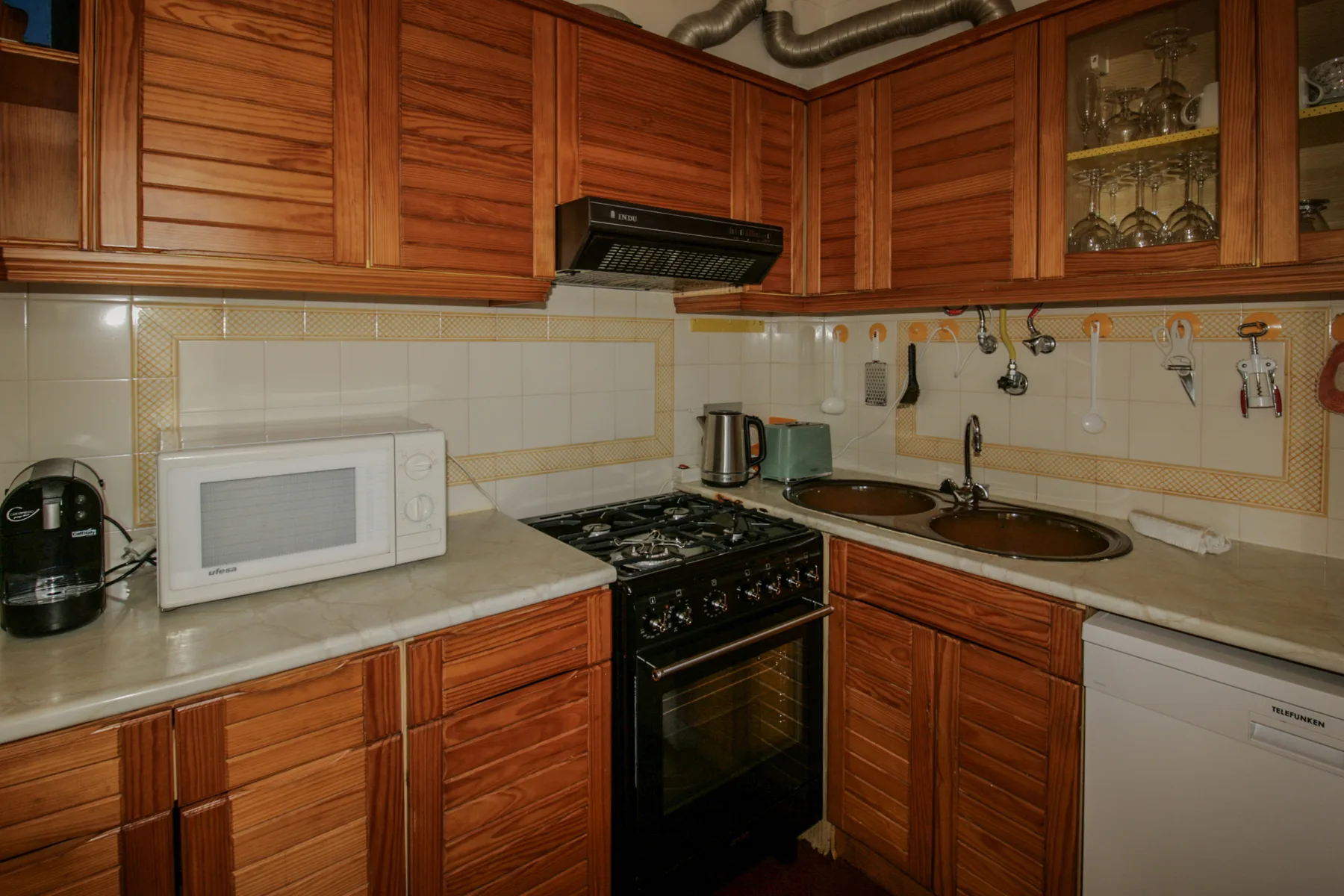 A kitchen with wooden cabinets, a stove, and counter space.