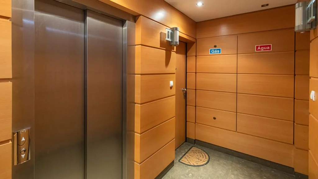 An elevator lobby with closed doors and wall-mounted floor labels.
