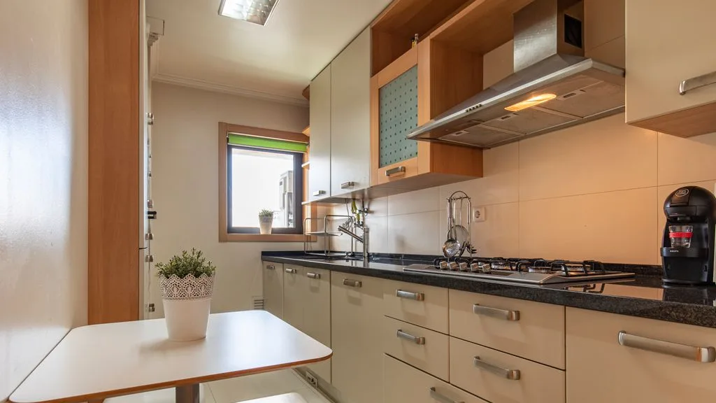 A modern kitchen with light cabinets and a counter.