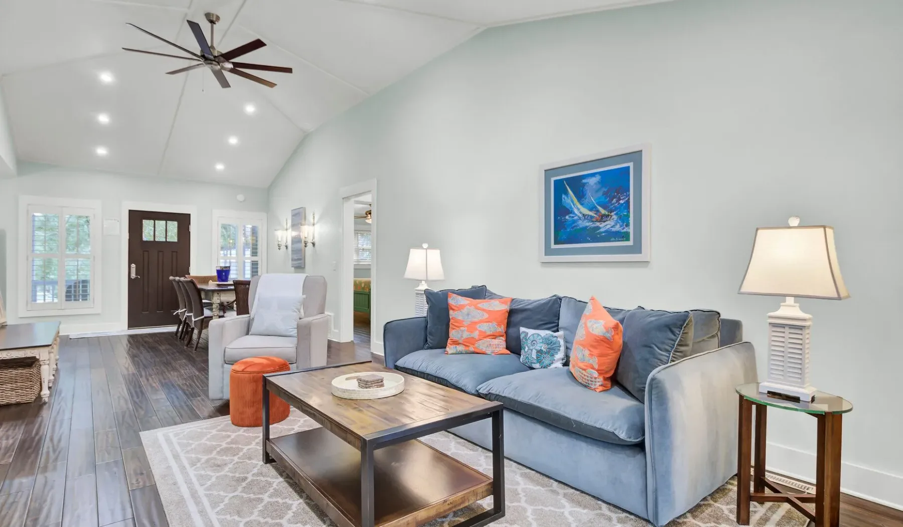 A bright living room with a blue sofa and a coffee table.