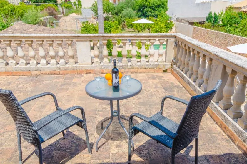 A terrace seating area with a small round table and two chairs.