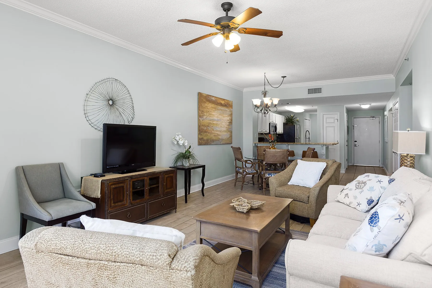 A living room with seating, a television, and a coffee table.