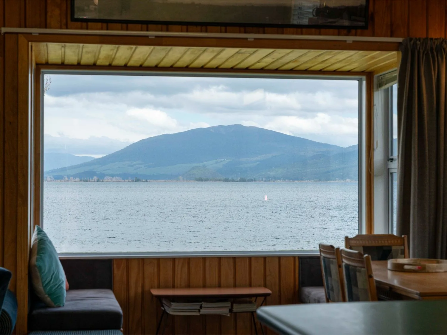 A view of a mountain and water through a window at the property in