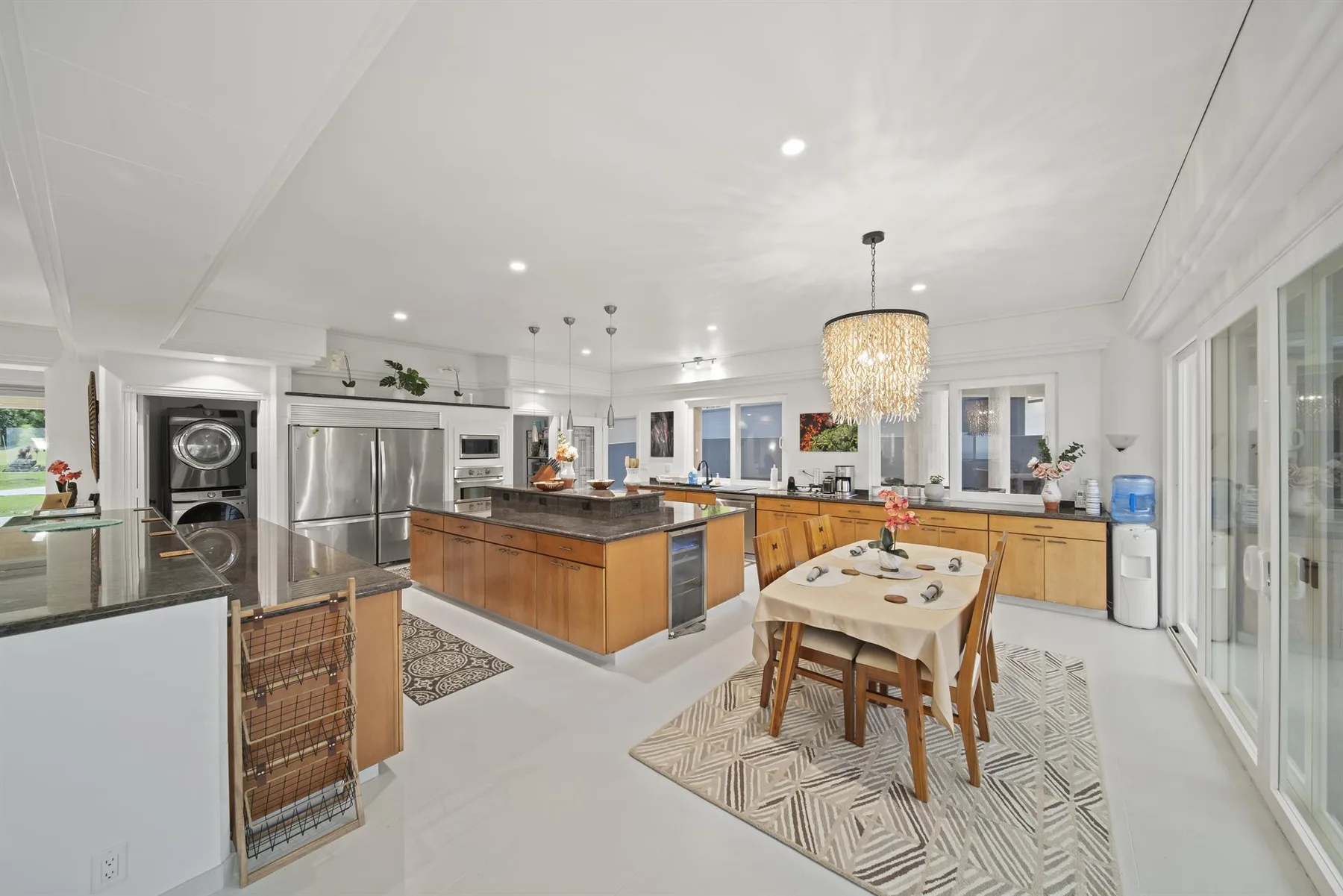 A bright kitchen and dining area with a central island and table.