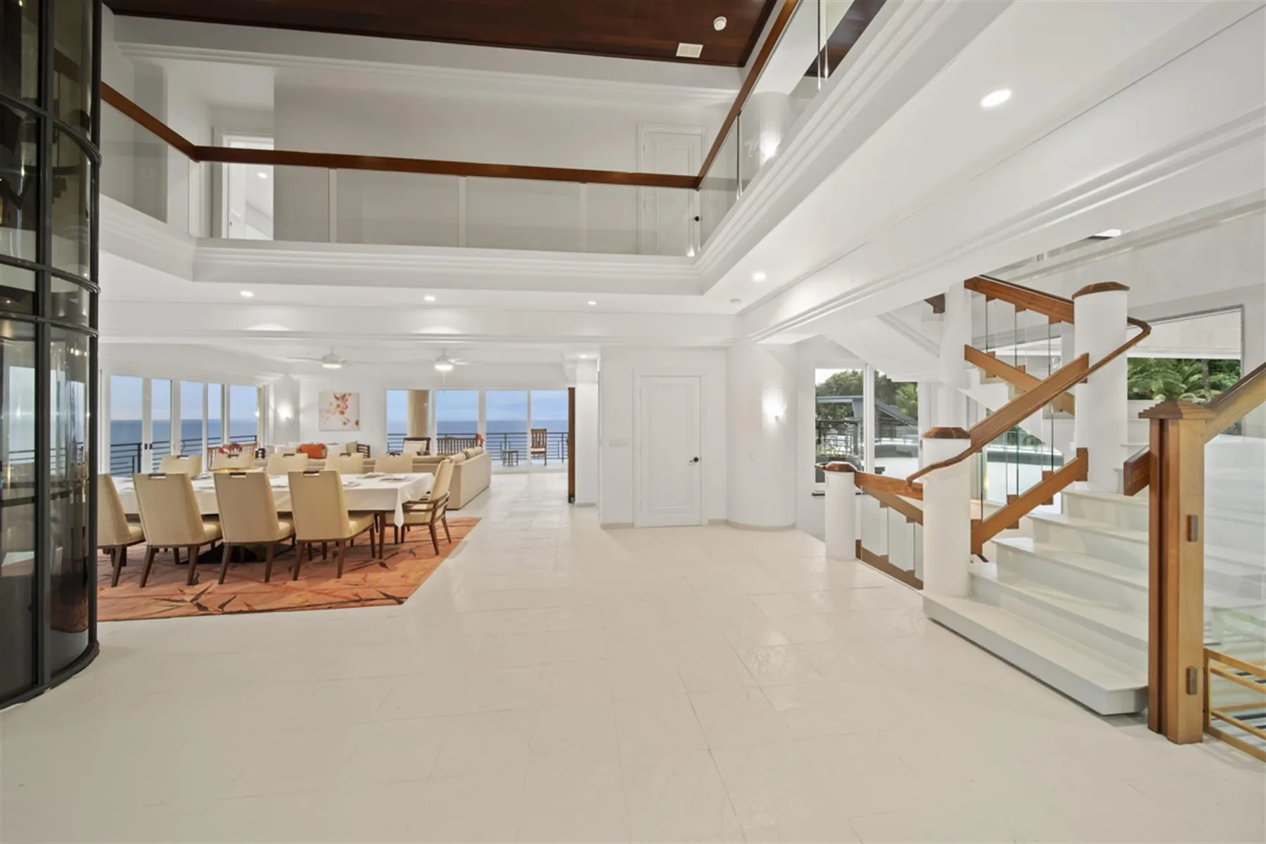 A bright open interior with a dining area and staircase.