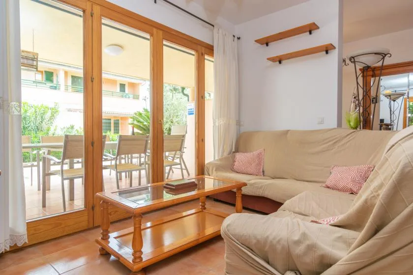 A living room with seating beside large glass doors opening onto a patio.