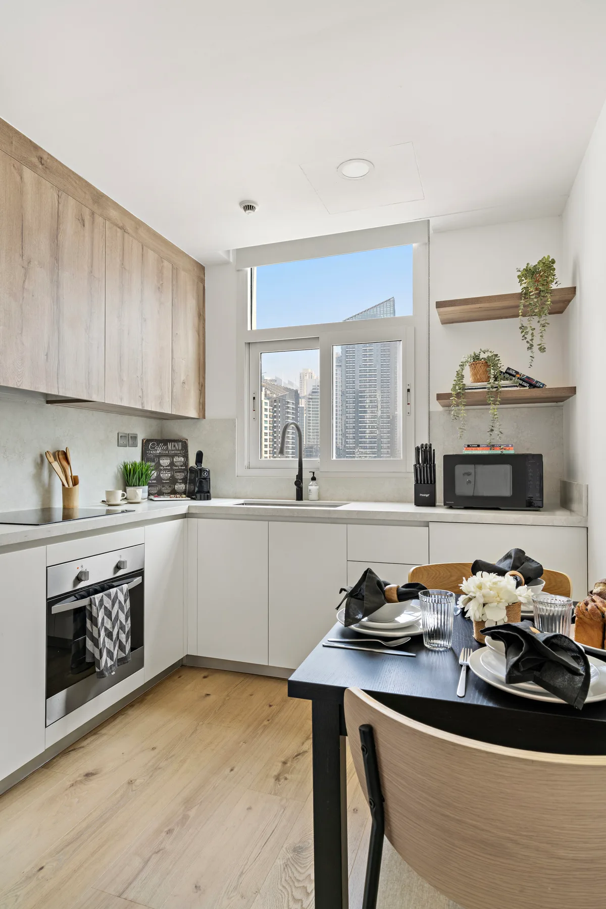 Una cocina luminosa con una mesa de comedor junto a grandes ventanas.