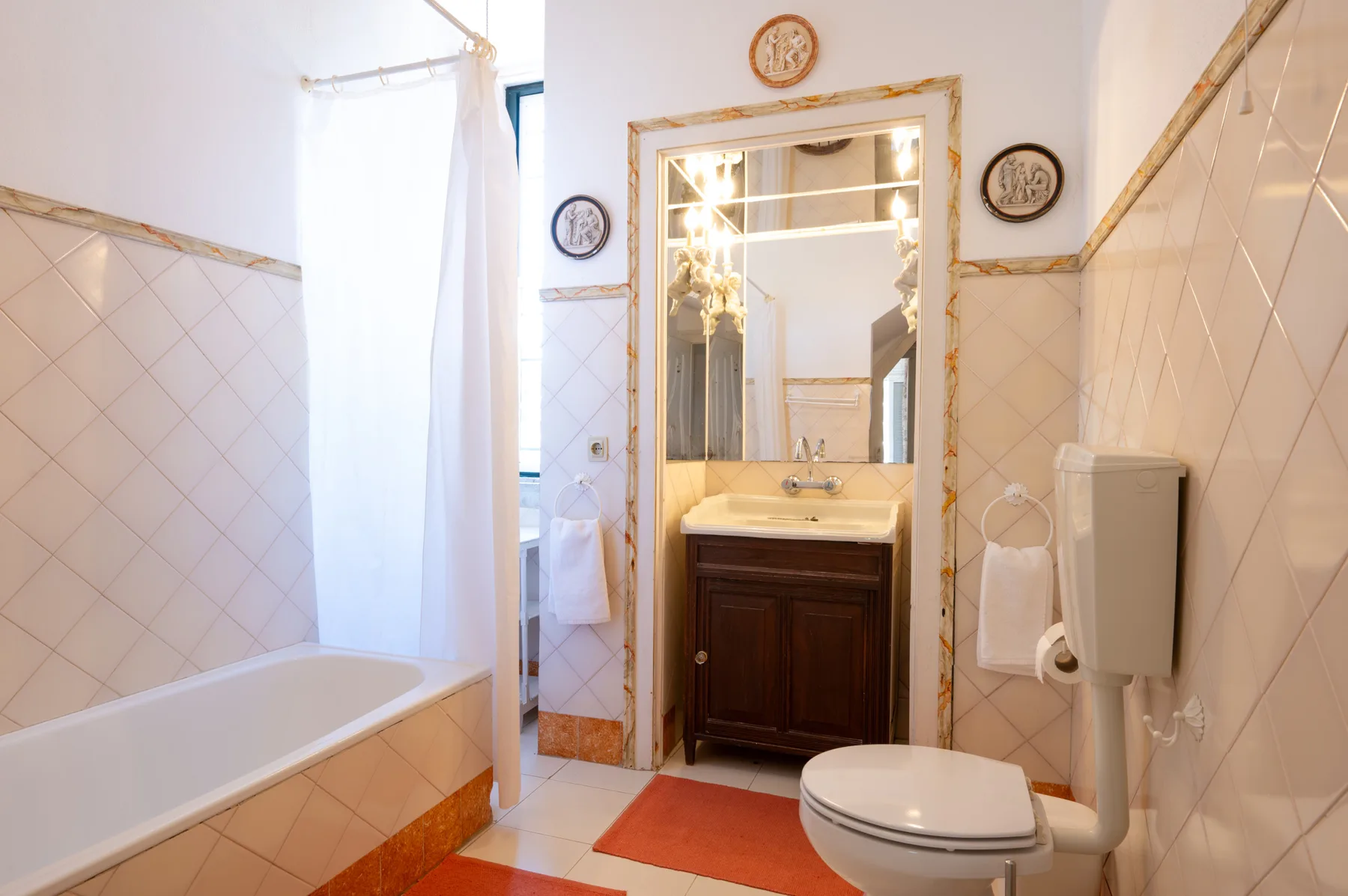 Un baño con bañera, lavabo e inodoro.