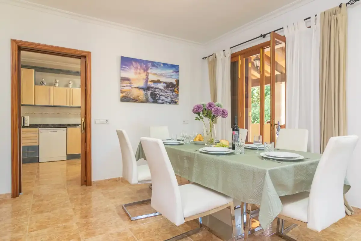 A dining area with a table set beside a large window.