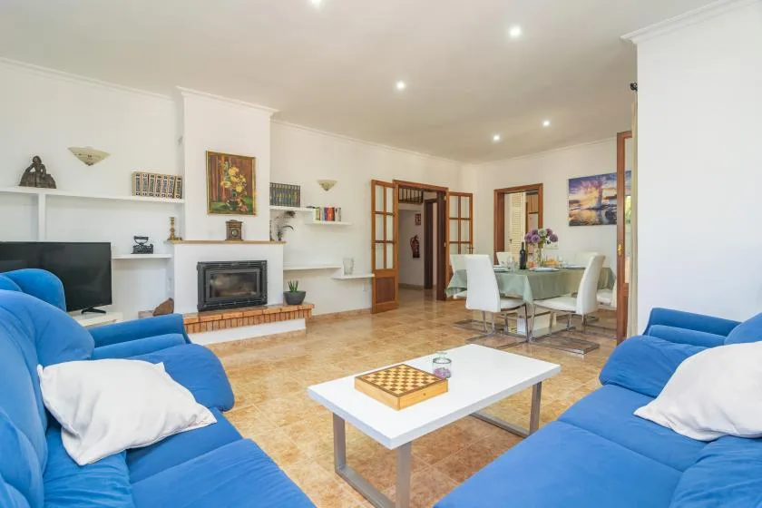 Bright living room with blue seating and a white coffee table.
