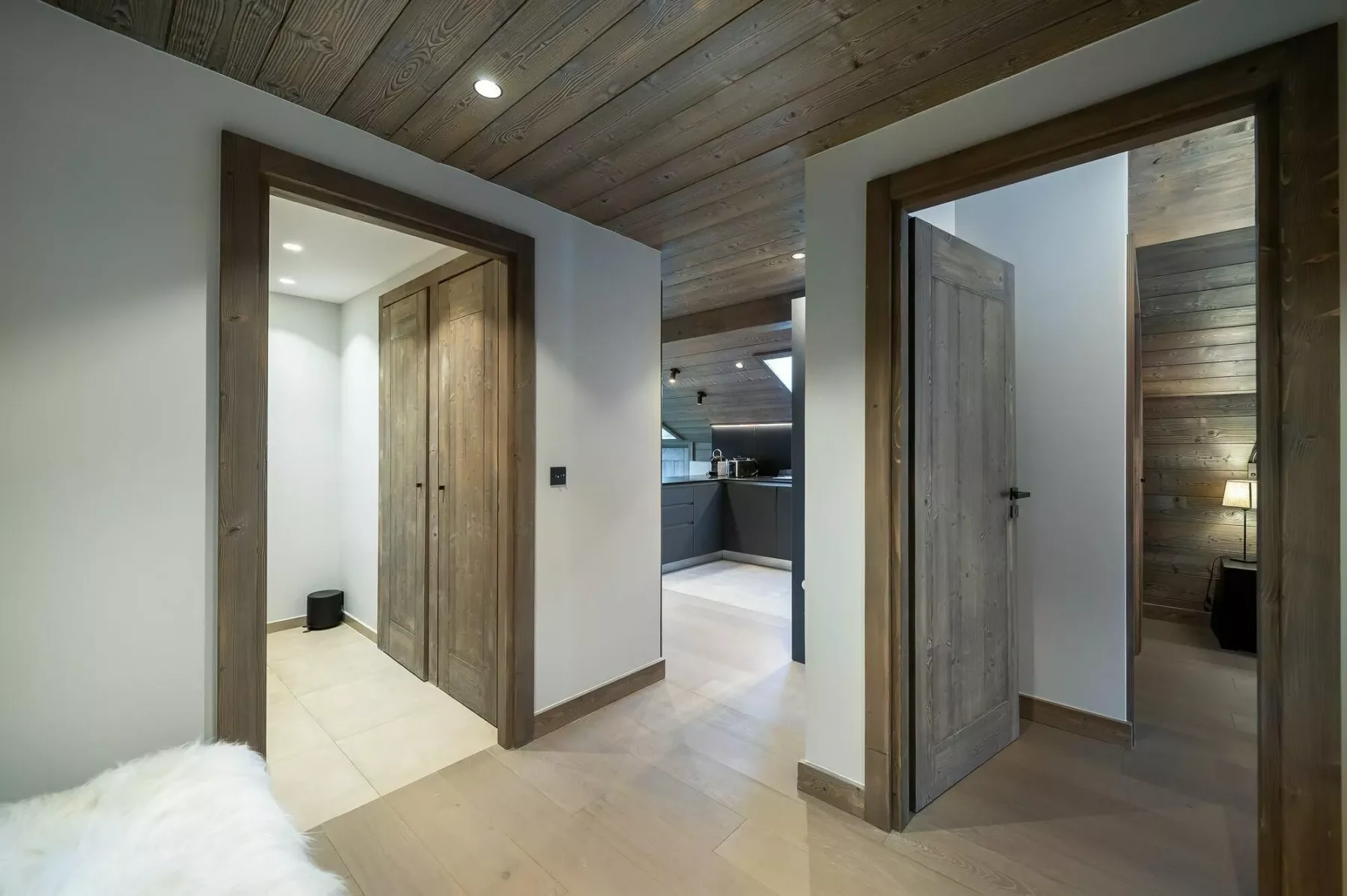 A wood-paneled hallway connects several rooms through open doorways.