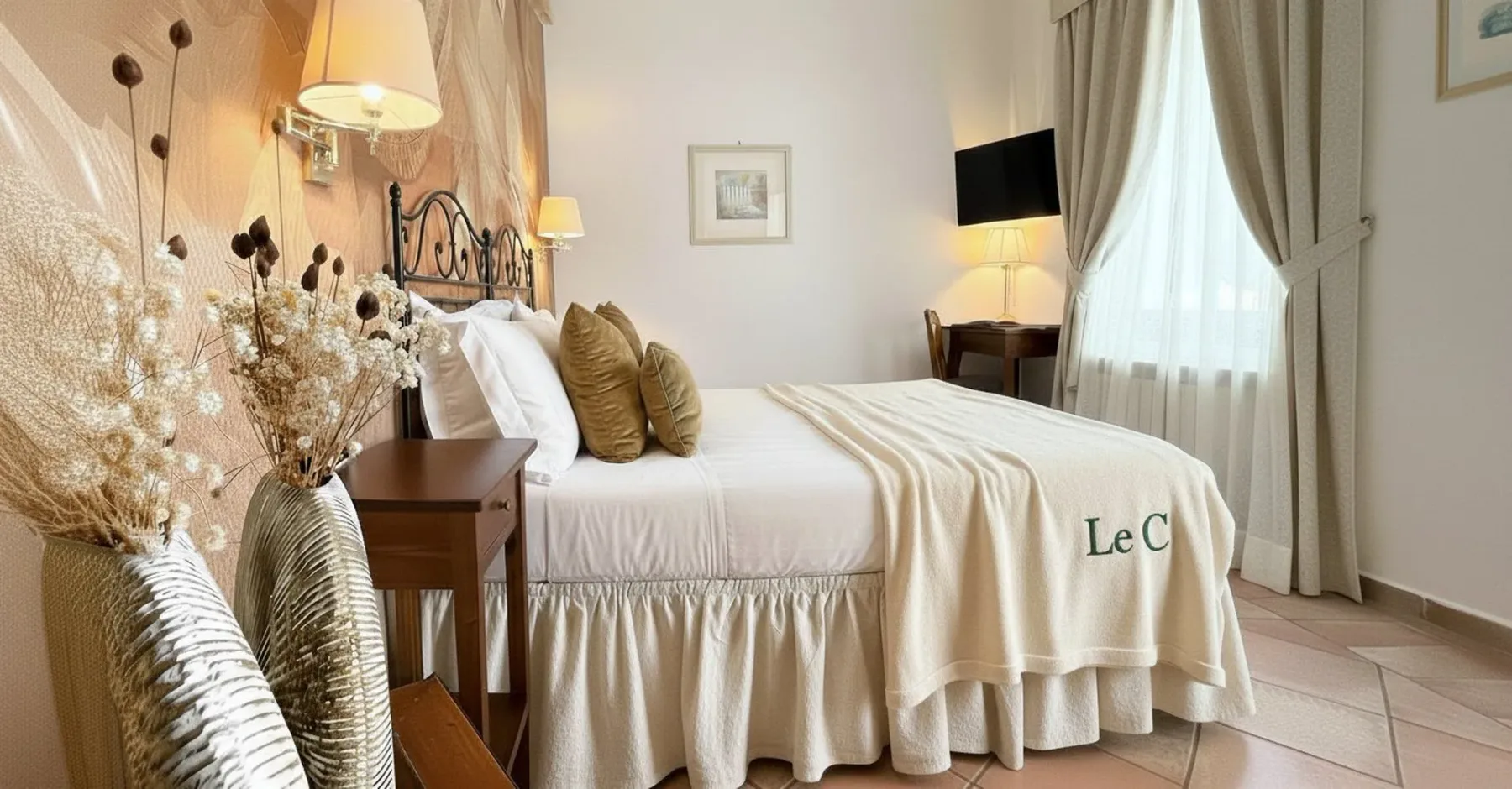Dormitorio con cama, mesita de noche y ventana con cortinas.