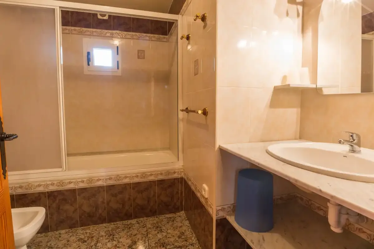 A bathroom with a shower and a sink.