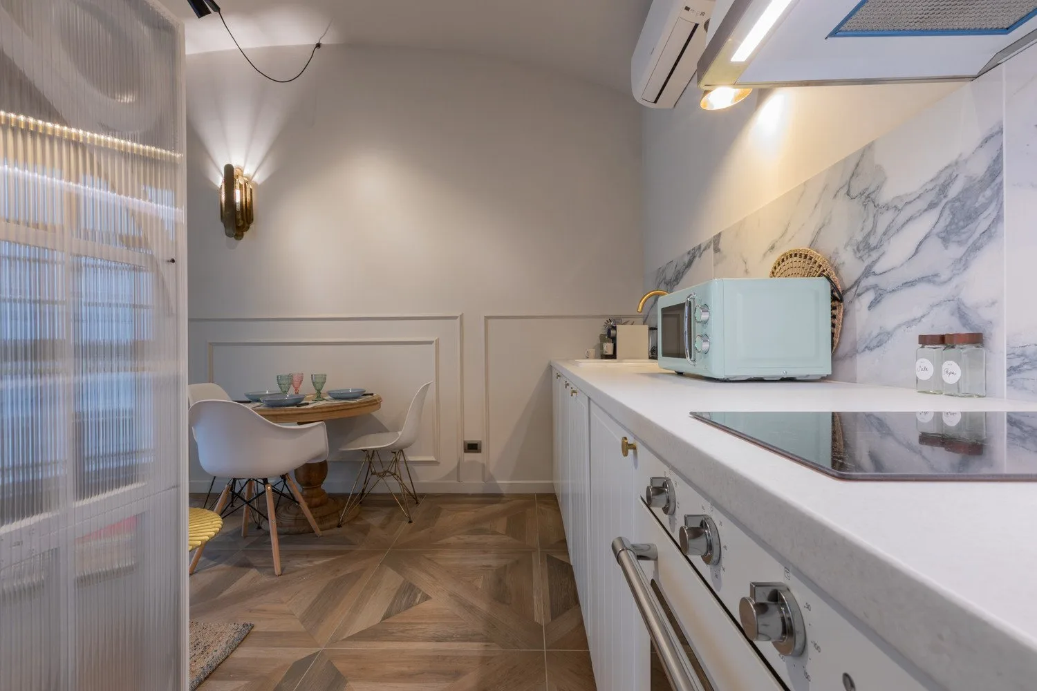A compact kitchen with a counter and dining table by the window.