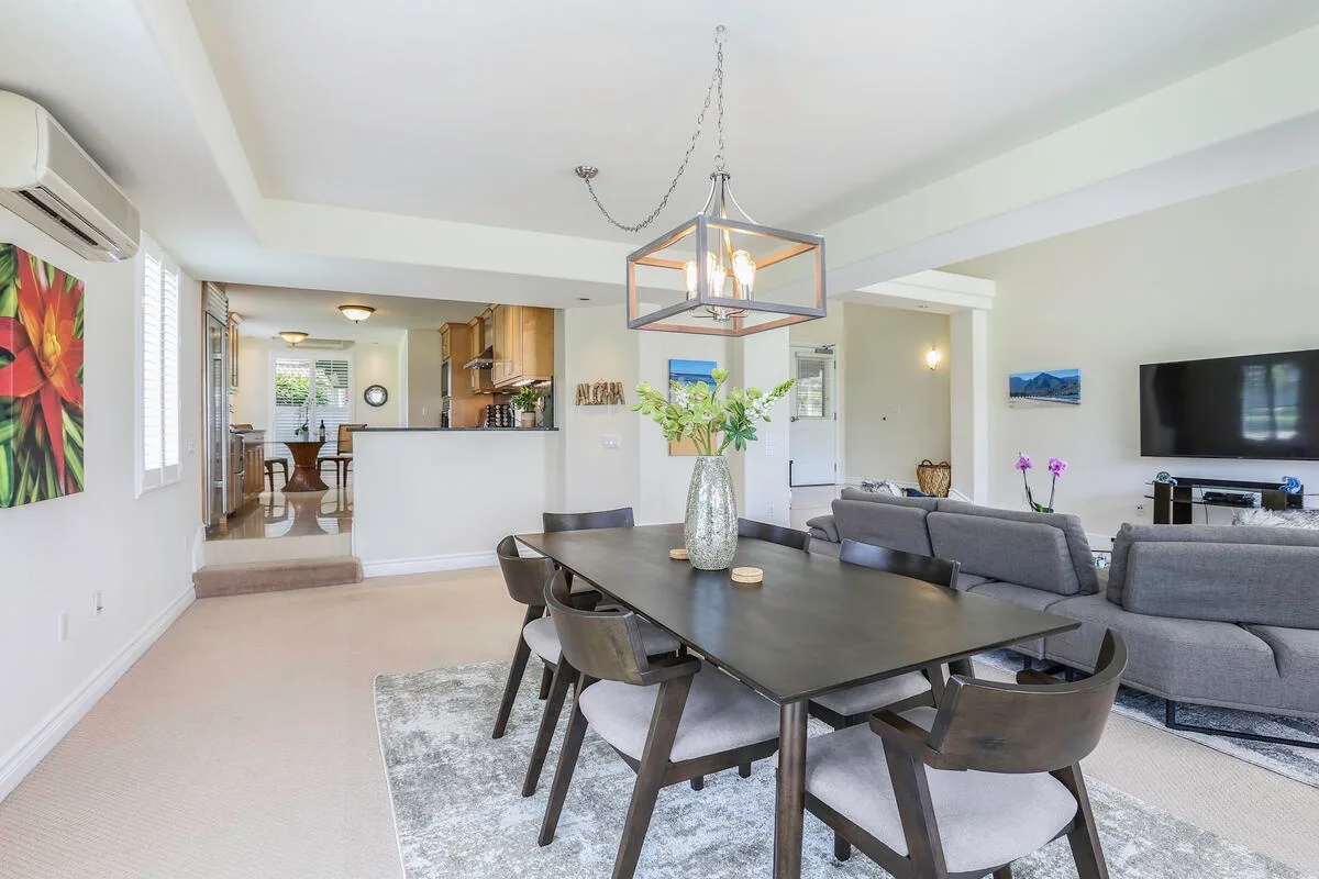 An open-plan dining and living area with a table and seating.