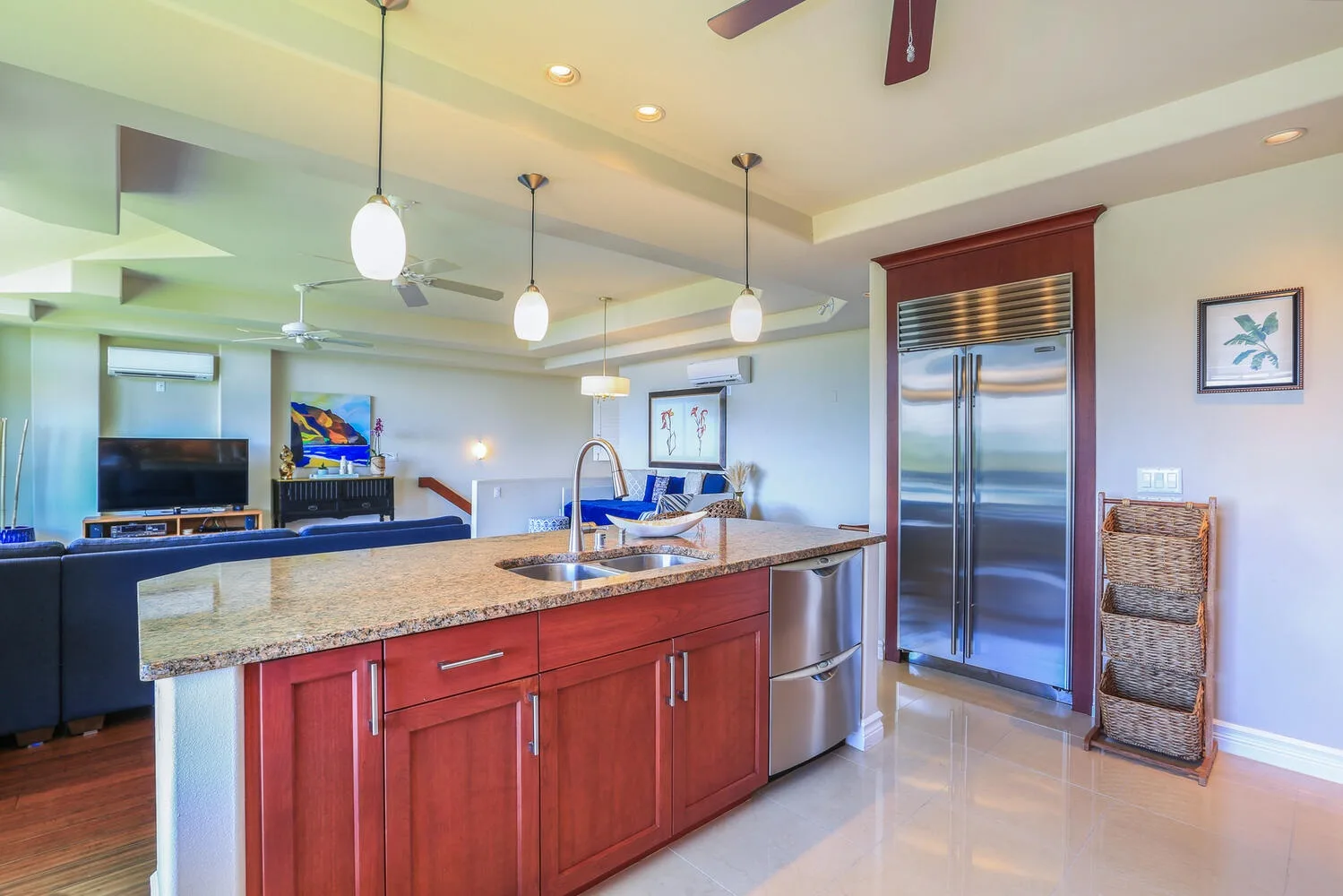 An open kitchen with a long island and stainless steel appliances.
