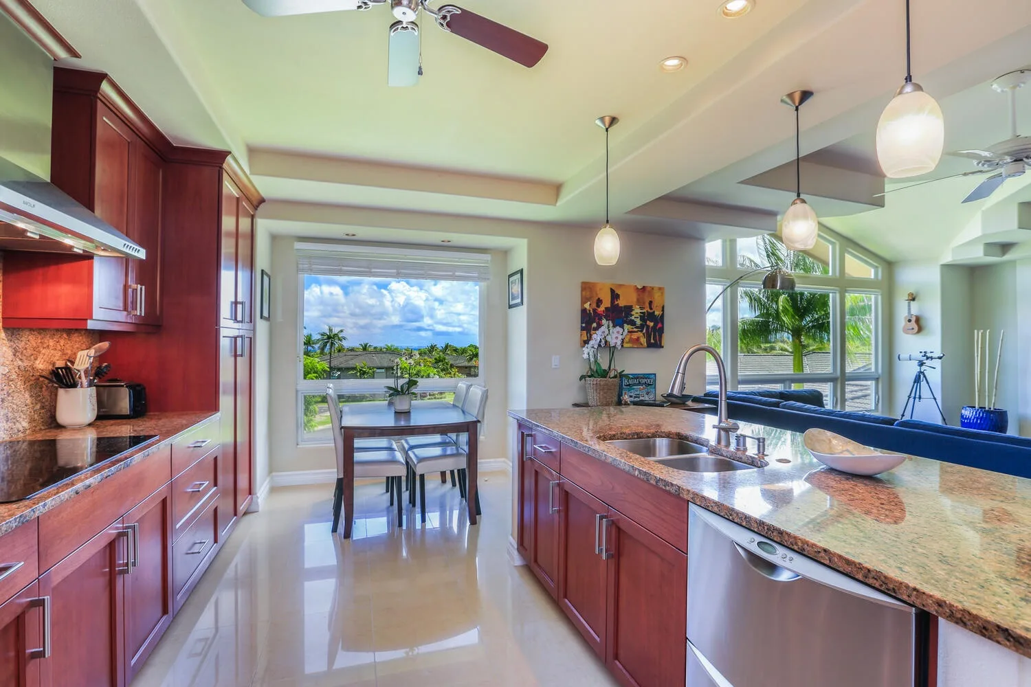 A bright kitchen with a central island and a dining table by the windows.