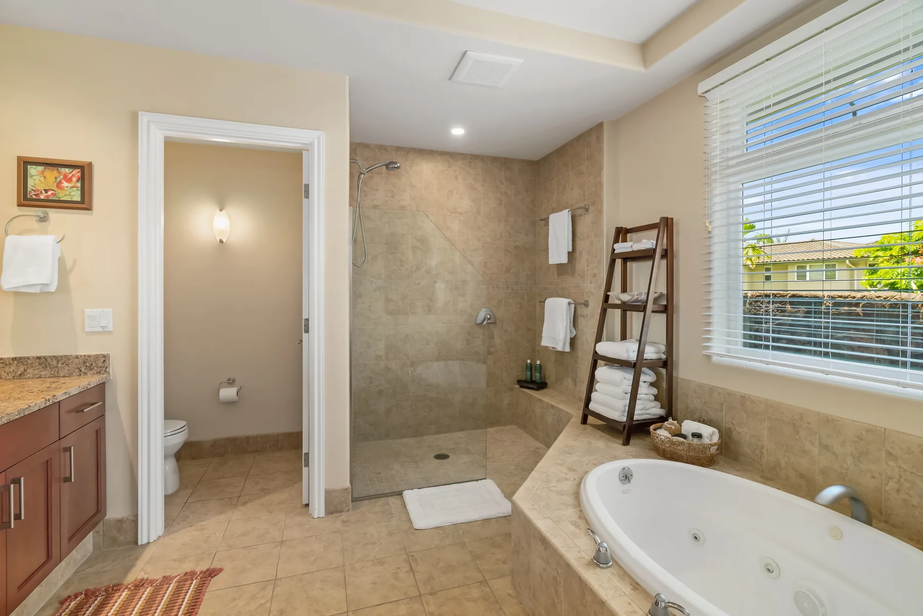 A bathroom with a walk-in shower, bathtub, and window with blinds.