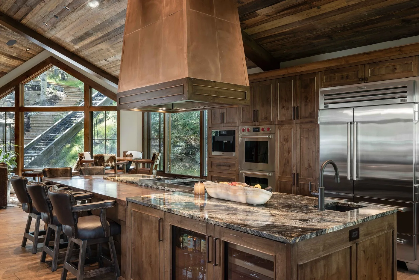 A spacious kitchen with a large island and wood cabinetry.