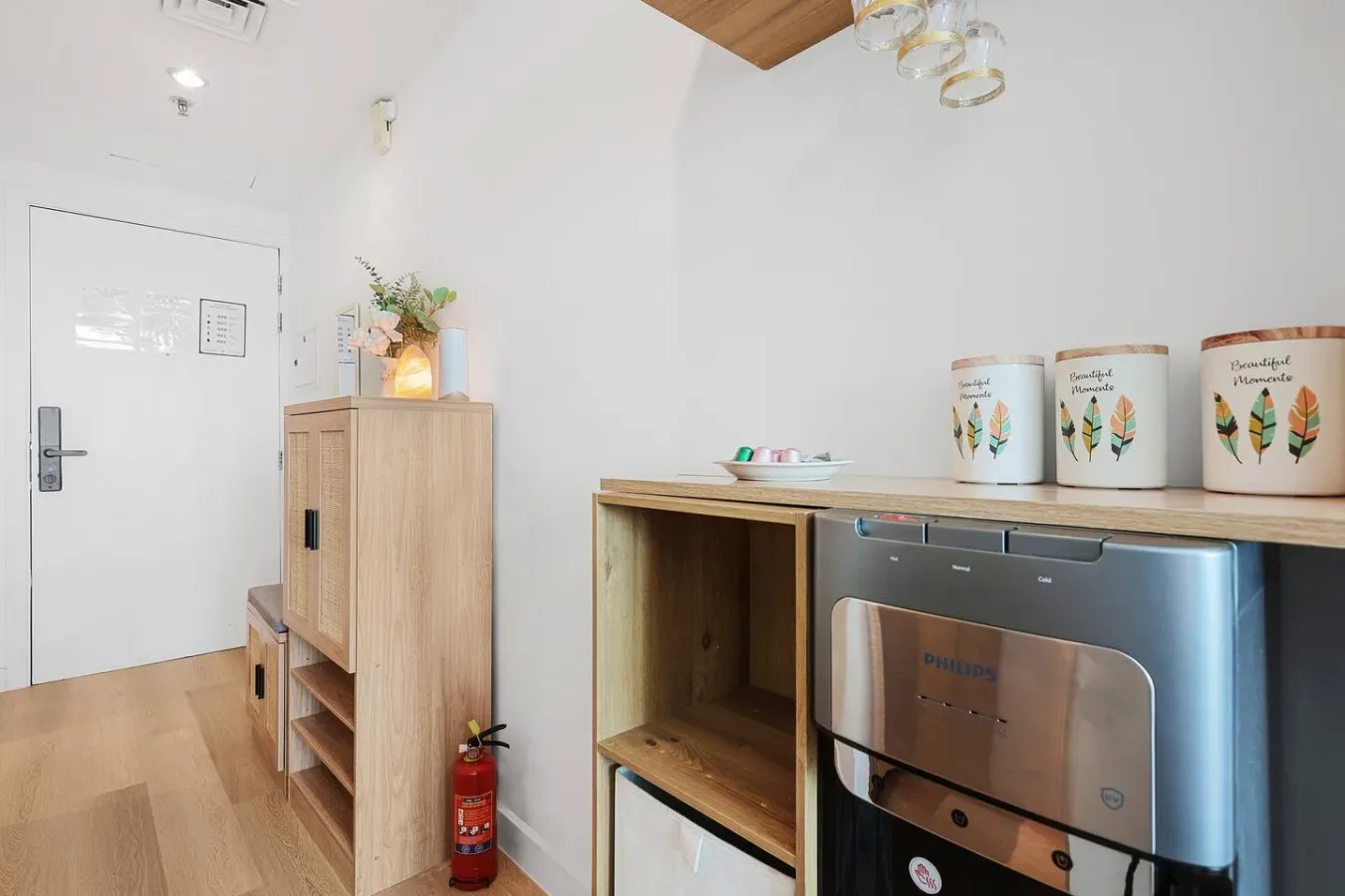 A bright kitchenette with a countertop oven and light wood cabinetry.