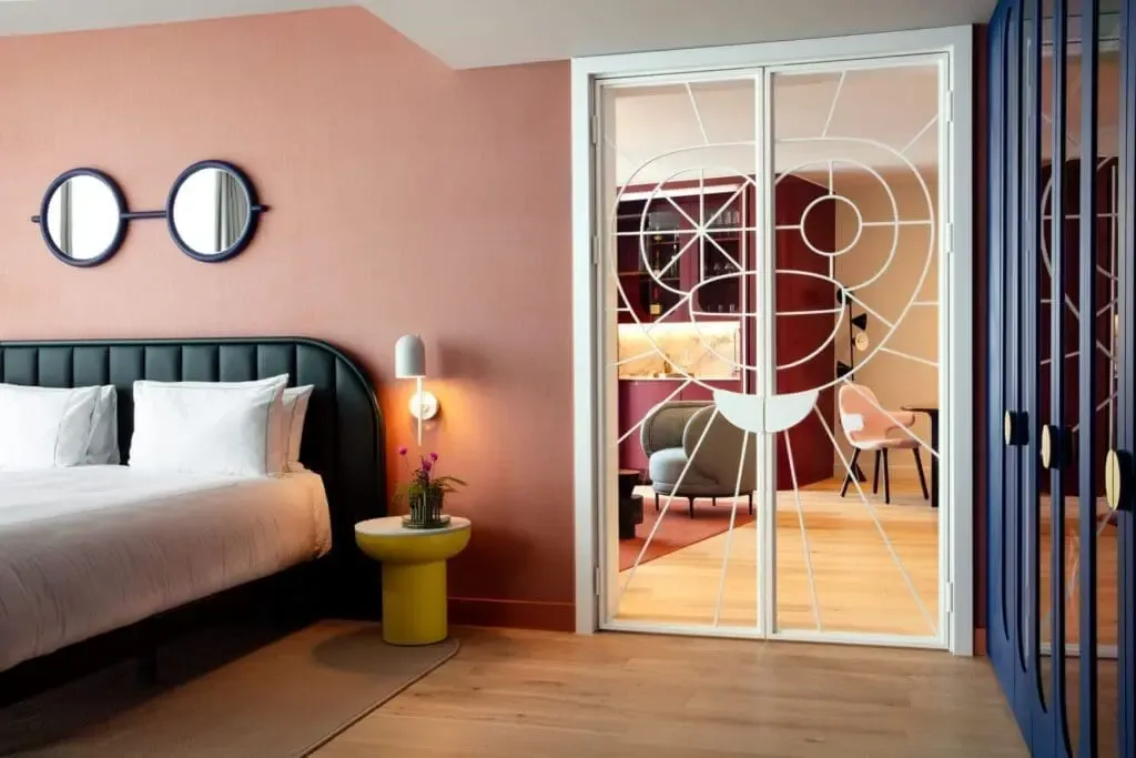 Hotel guest room with a bed and contemporary artwork.