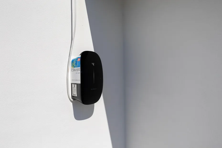 Un dispositivo montado en la pared está fijado a una pared blanca.