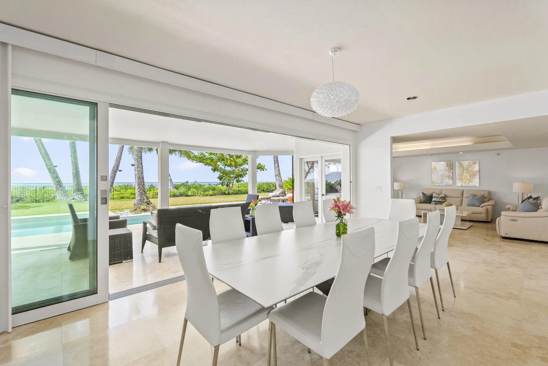 A bright dining area opens onto a patio and a living room.