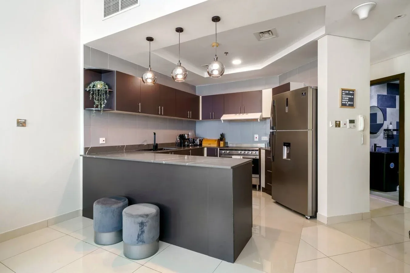 A modern kitchen with dark cabinetry and a large central island.