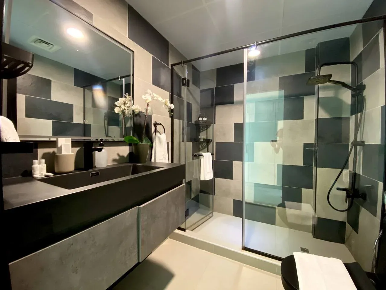 A modern bathroom with a wide vanity and a glass shower.