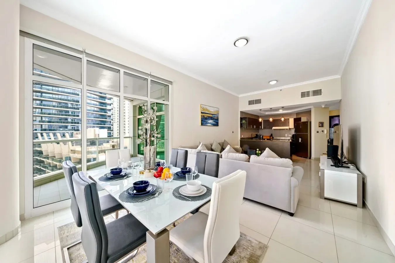 An open-plan living and dining area with a dining table beside the lounge.