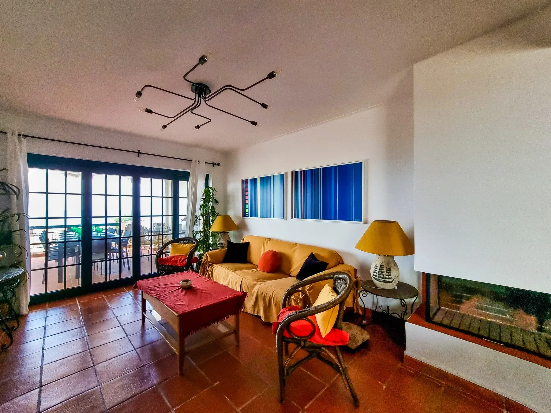 Living room with seating, a coffee table, and sliding glass doors opening to a balcony.