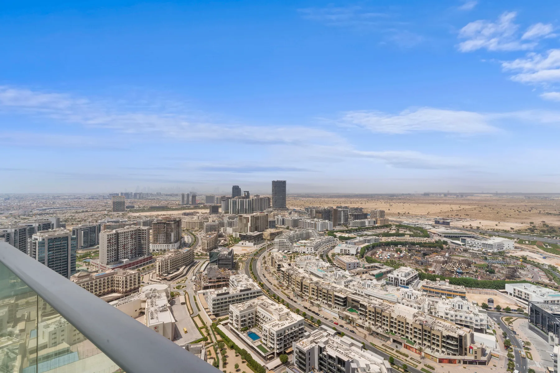 Un panorama urbano de edificios modernos bajo un amplio cielo azul.