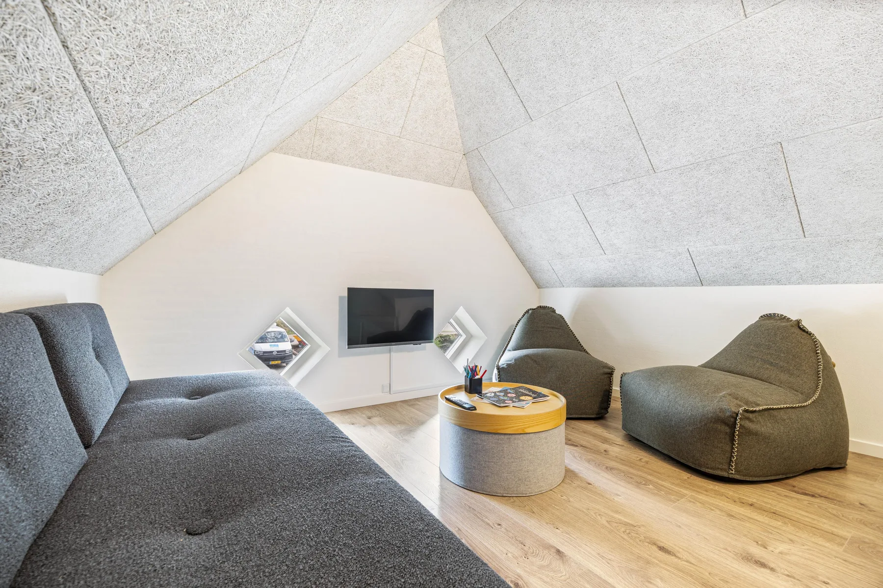 A lounge area with a television, low table, and casual seating.